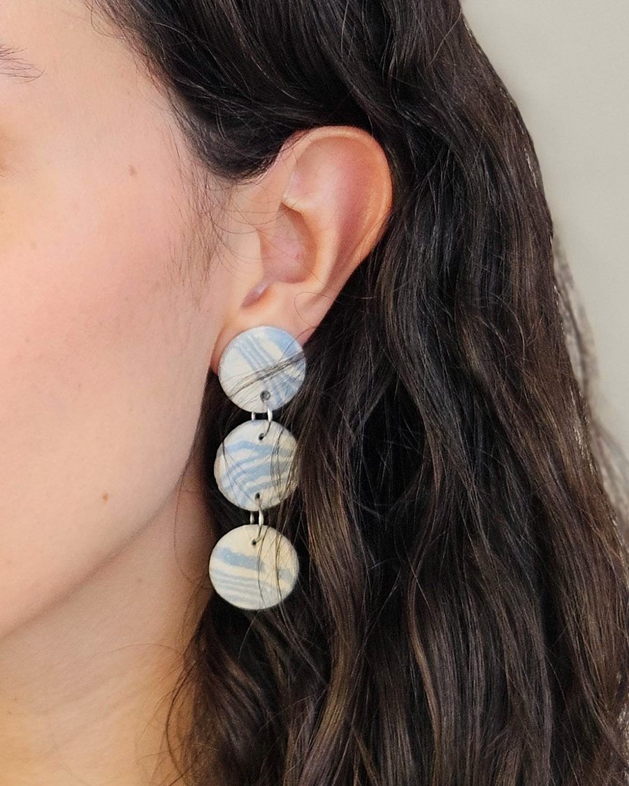 Three-tier marbled blue drop earring, worn
